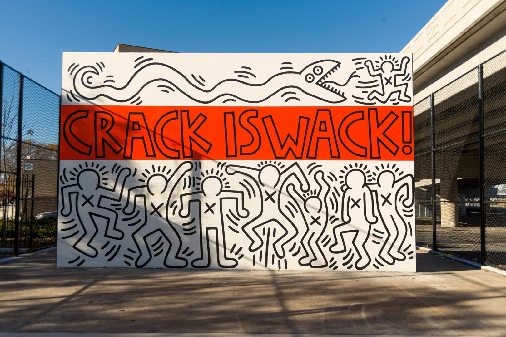 Public anti-drug mural with the slogan "crack is wack!" featuring stylized figures and patterns.