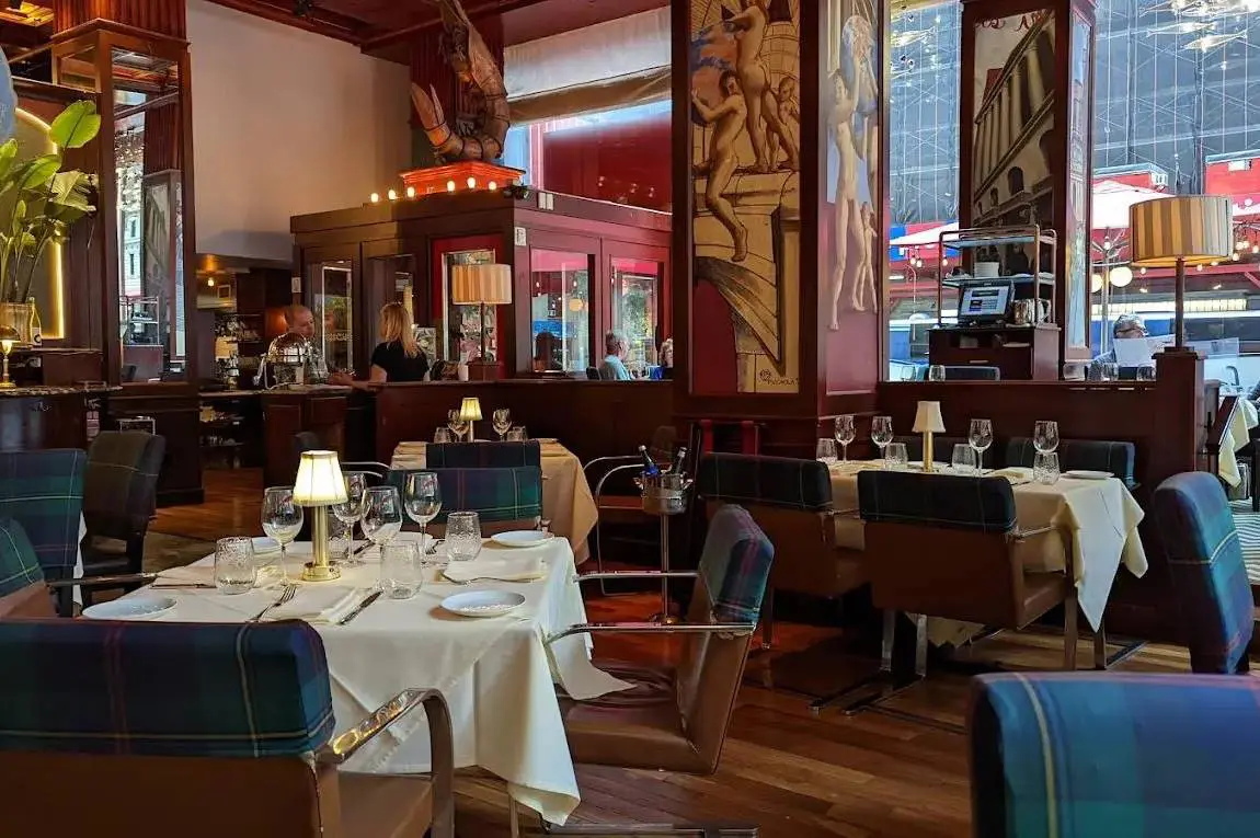 Interior of a restaurant with set tables and classic decor.